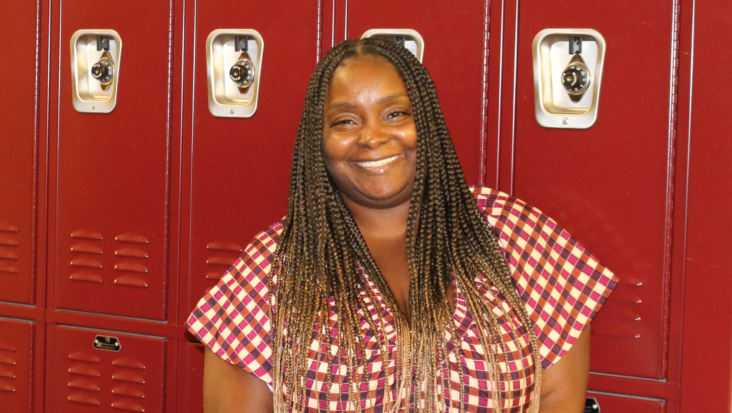 Kwan Robinson standing in front of school lockers.