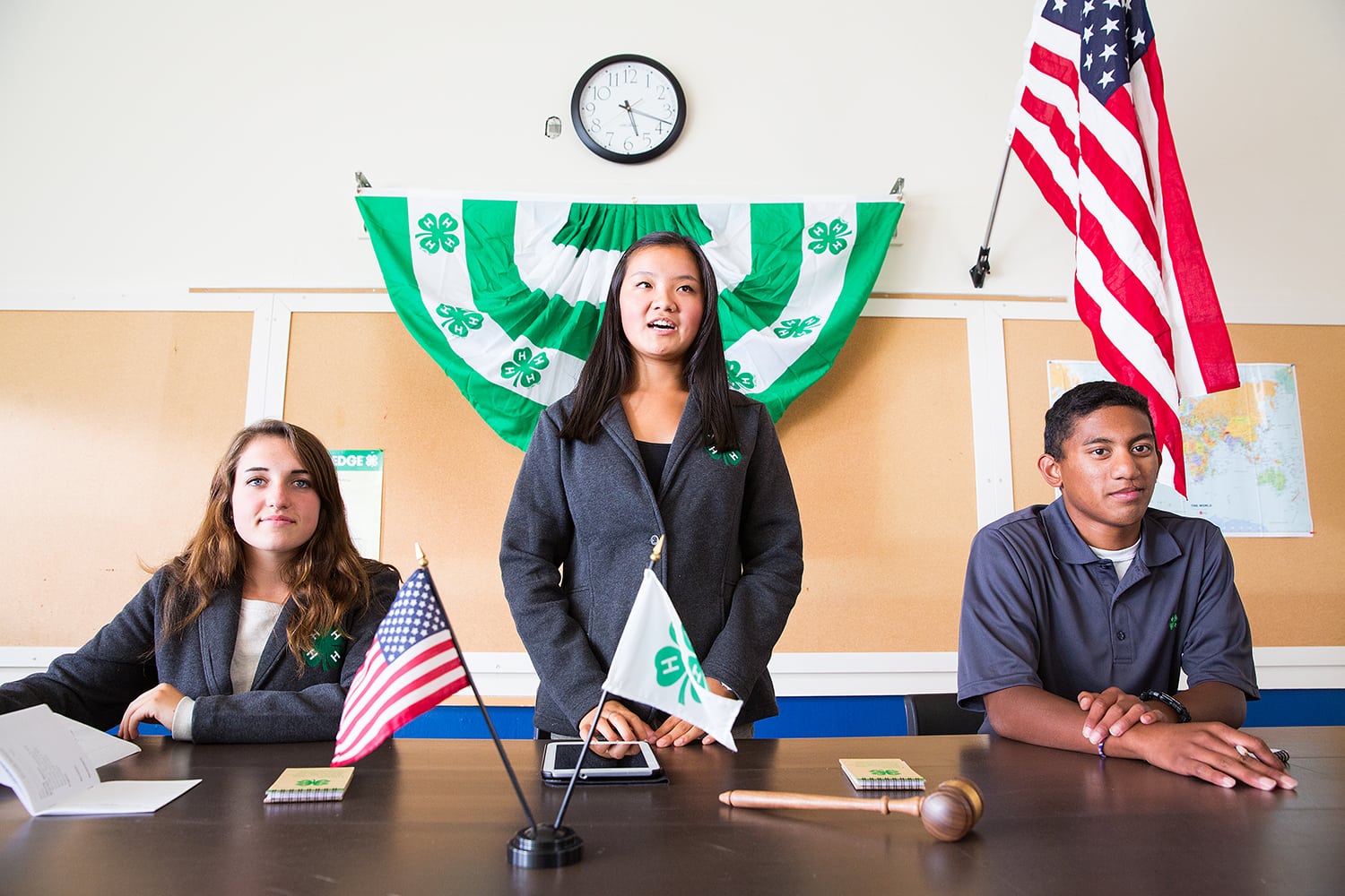 Group of 4-H leadership at table in front of club
