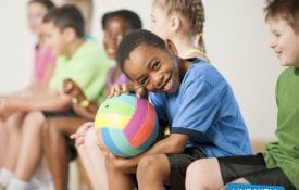 Quest for Healthy Schools boy holding ball in gym class