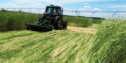 A tractor pulls a roller/crimper through a field. This conservation system practice terminates the cover crop by crimping it down. Farmers will plant into the heavy residue.