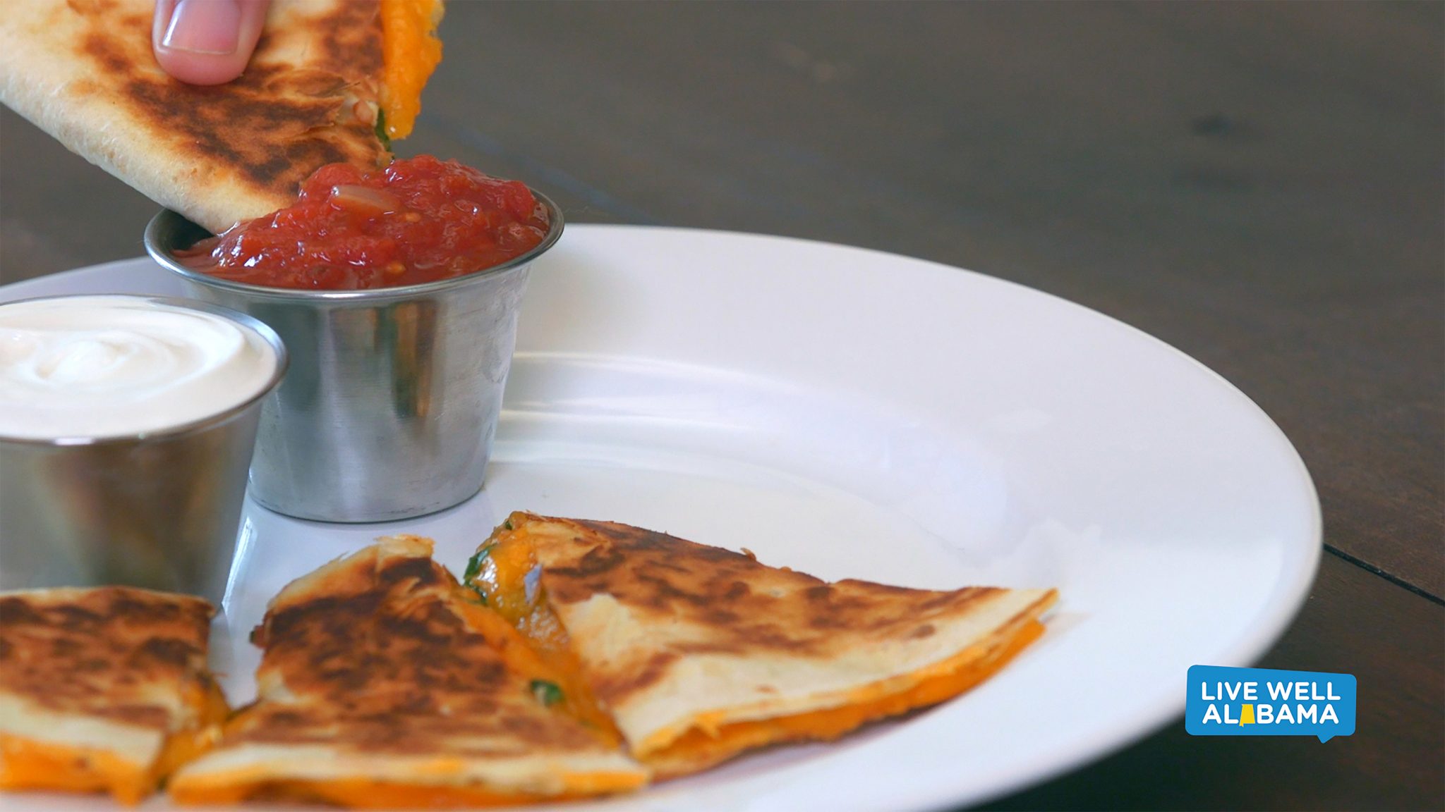 Cheesy quesadilla with spinach slices, dipped in salsa. Live Well Alabama recipe.