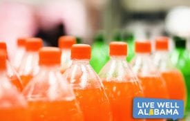 Bottles of orange soda in a supermarket, sugar