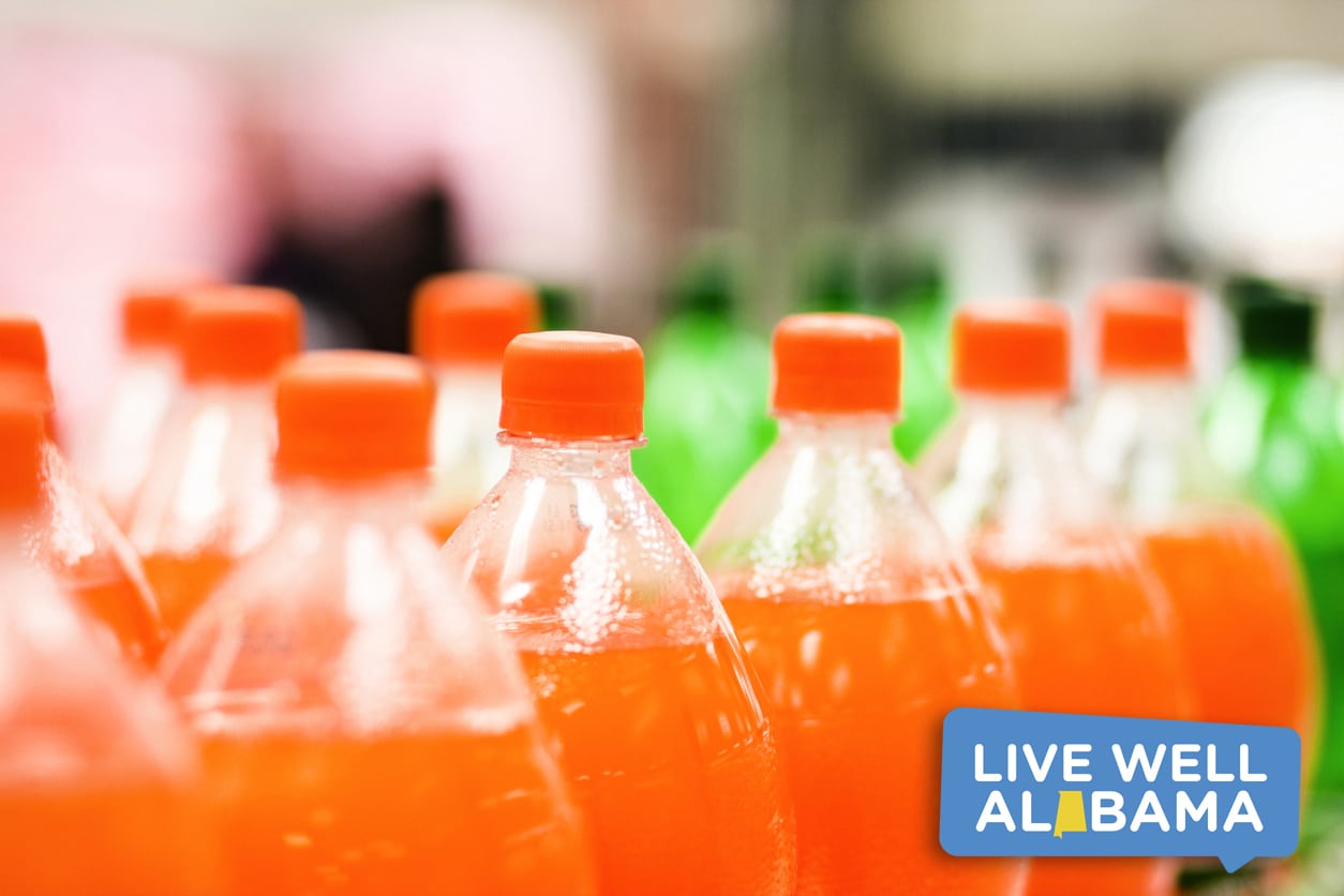 Bottles of orange soda in a supermarket, sugar