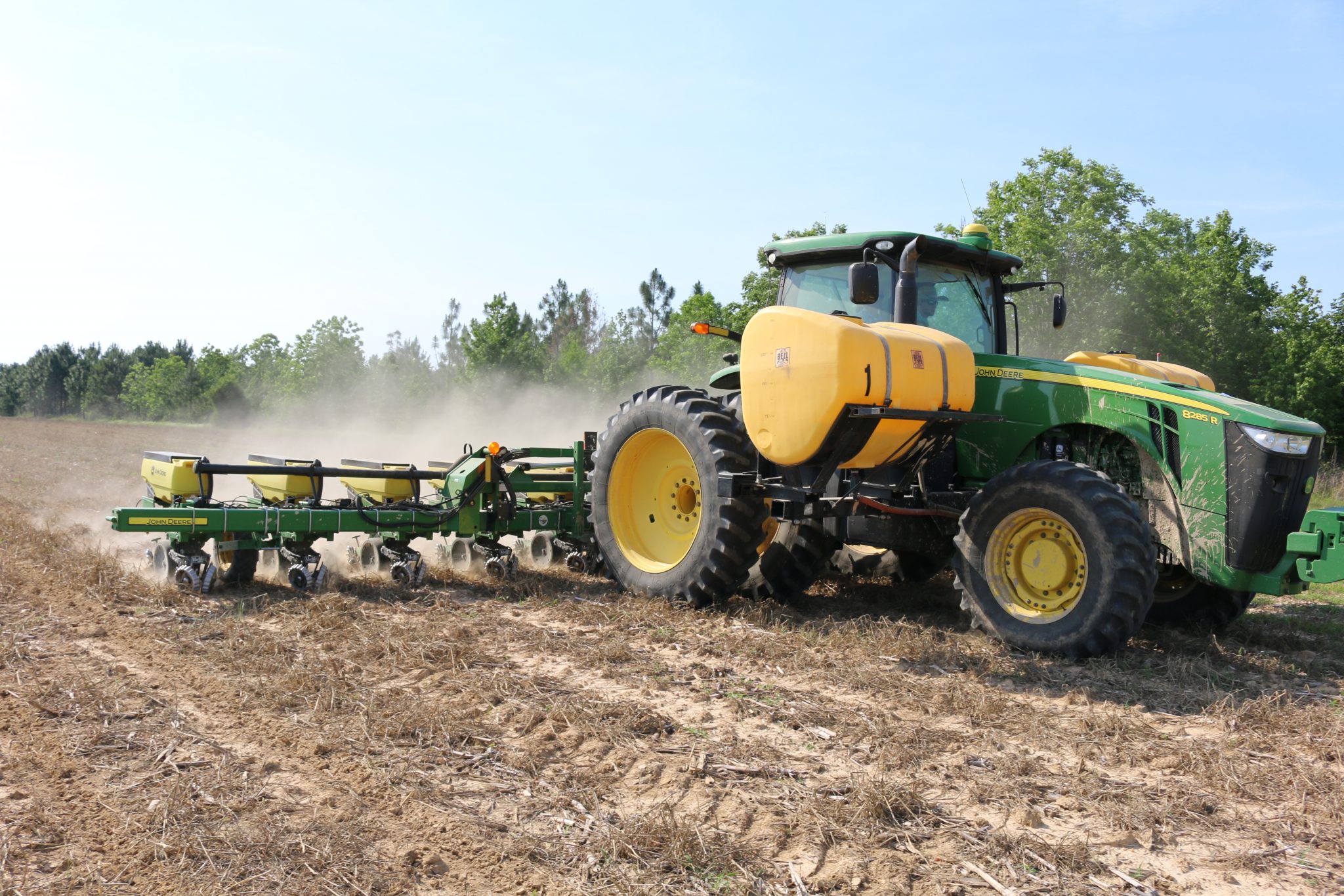 A tractor planting row crops.