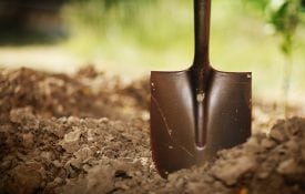 Soil with shovel. Close-up, shallow DOF. shutterstock.com/logoboom