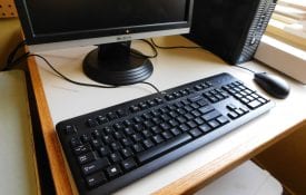 Image of keyboard, partial monitor and mouse