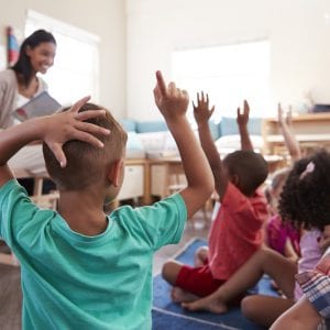 elemenstary school students Raising Hands To Answer Question