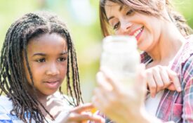 Alabama 4-H volunteer outdoors with 4-H member monitoring water quality