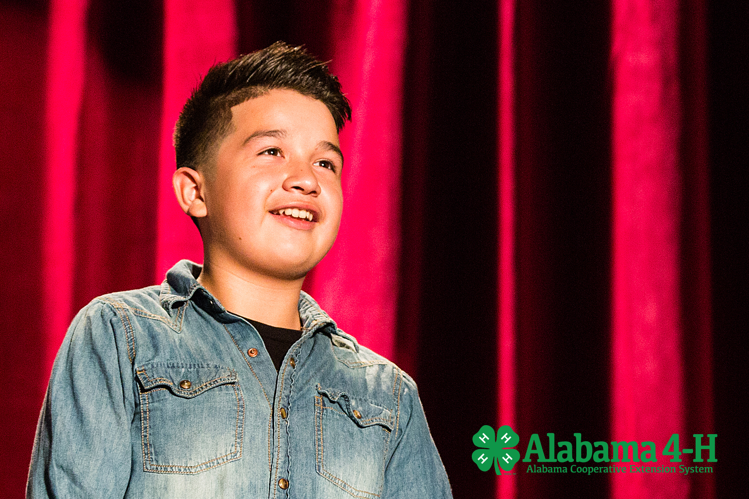 Alabama 4-H Junior Achievement; young boy speaking on stage