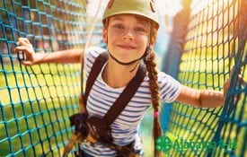 Alabama 4-H Character Counts curriculum; girl smiling on ropes course