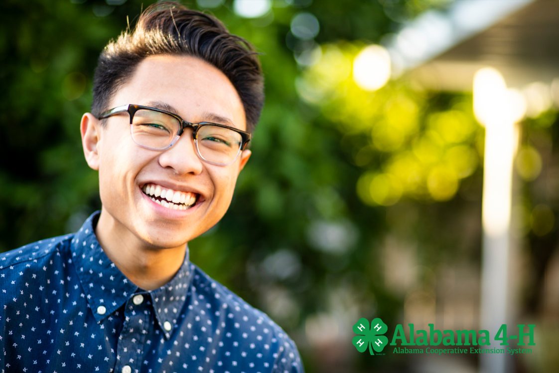 smiling student with reading glasses