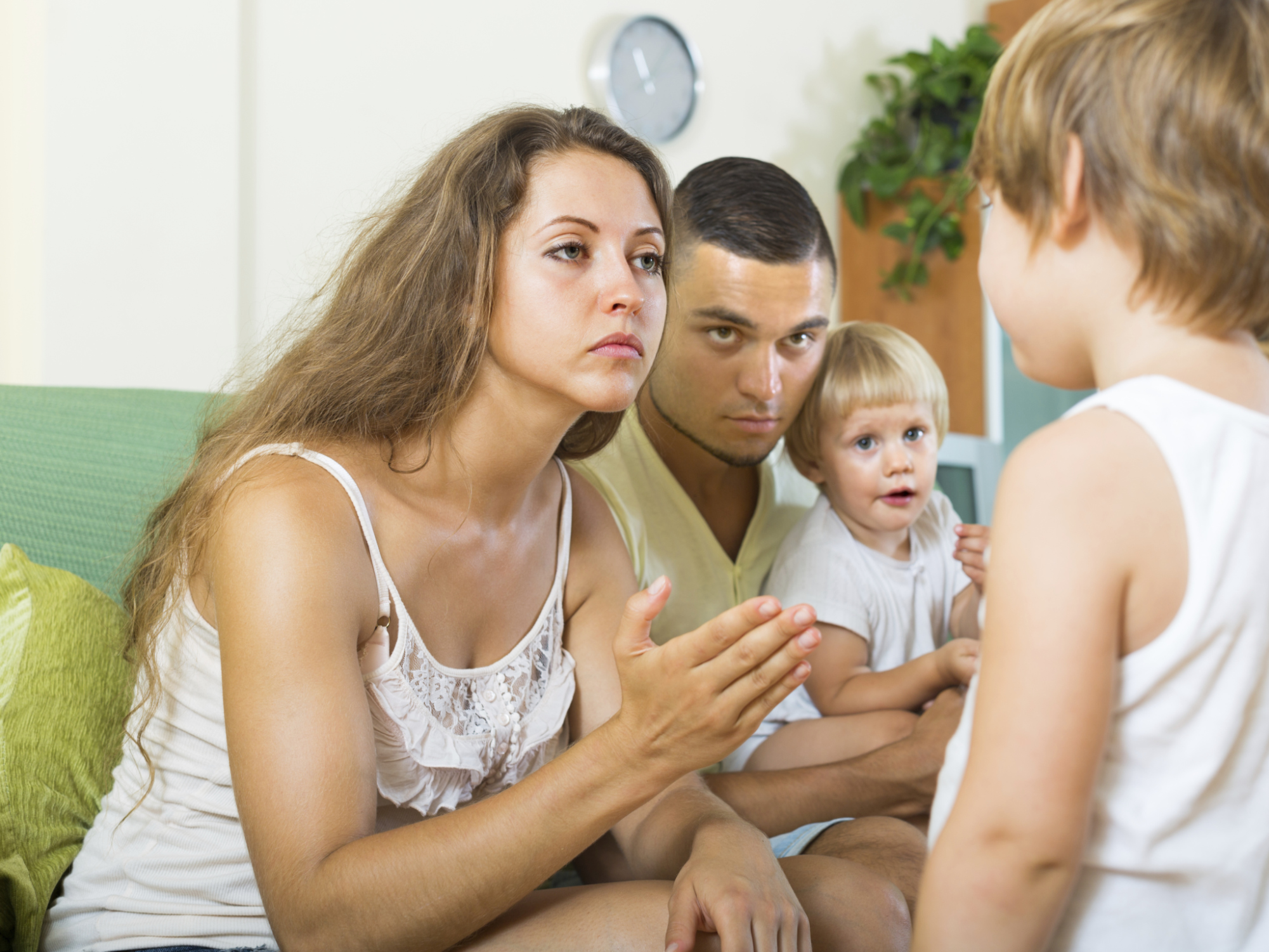 Parents scolding child in home