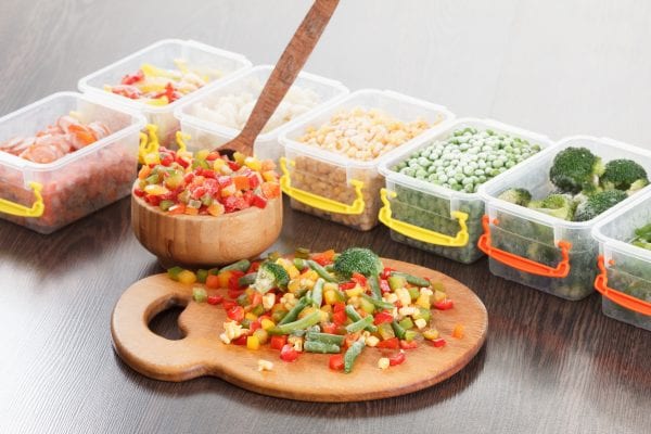 Food packaging ingredients, healthy frozen vegetables, cooking from freezer container.
