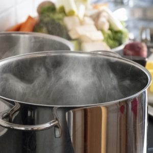 Blanching vegetables in big cooking pot preparation