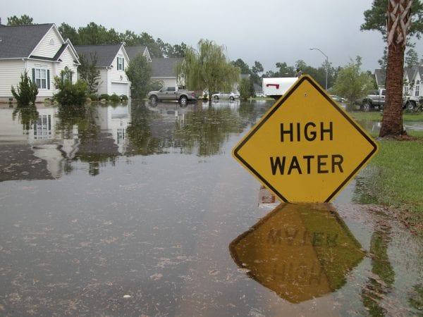 High Water Sign in Flooded Neighborhood