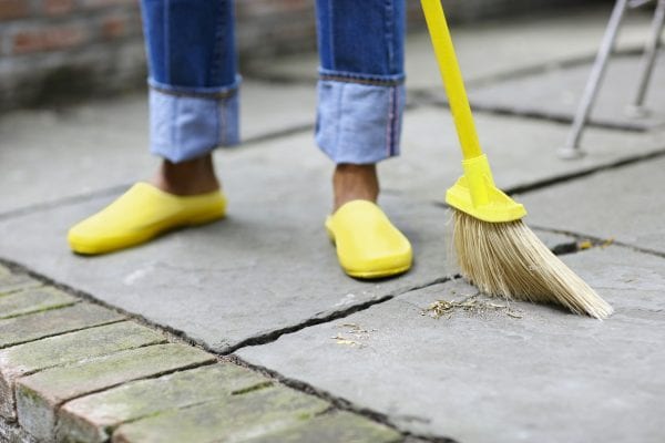 Woman Sweeping Patio