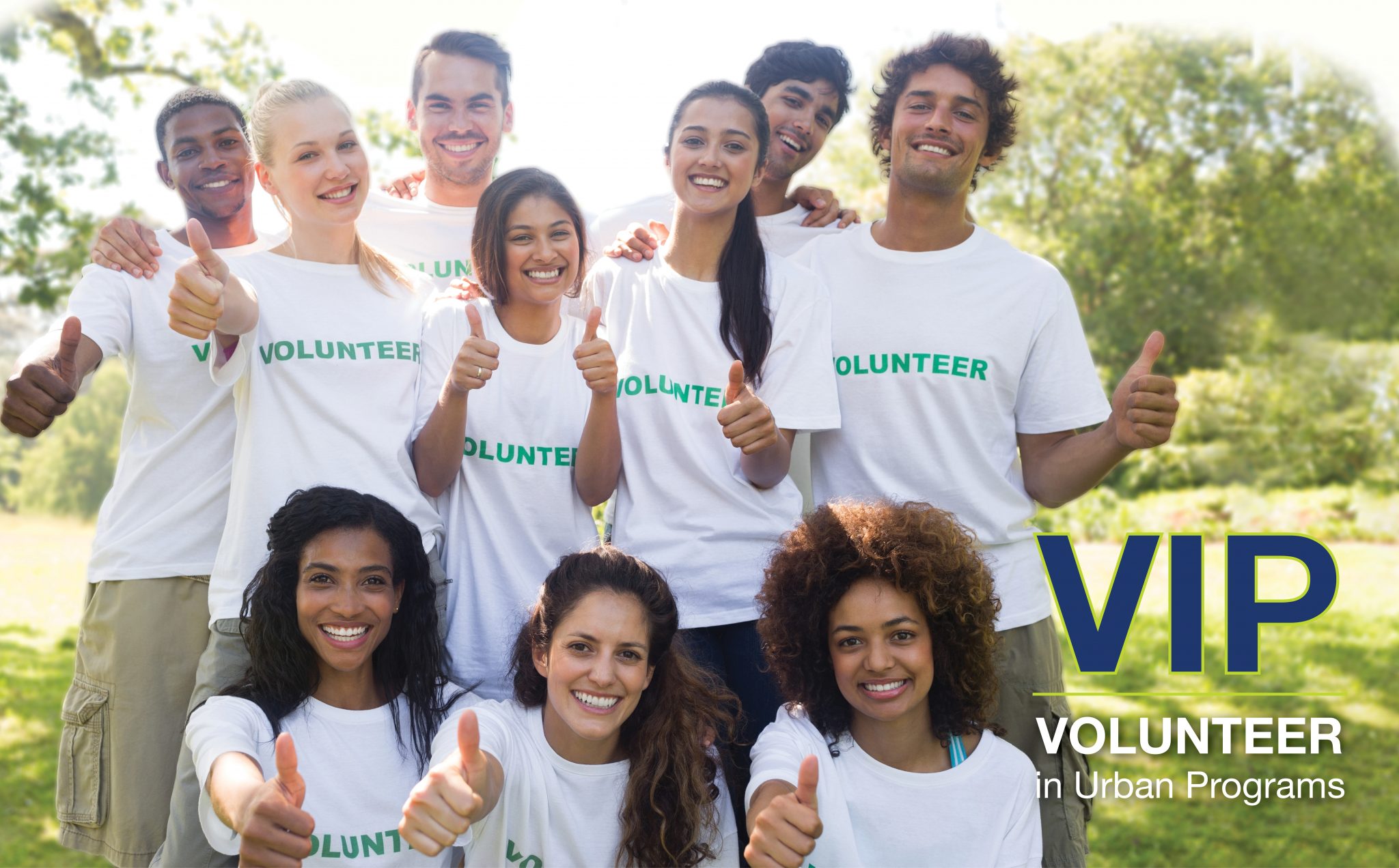 Group of ethnically diverse college students pose in Volunteer t-shirts.