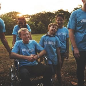 Diverse group of volunteers, young, older, one is in a wheelchair.