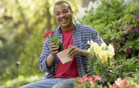 Black man sitting in a garden