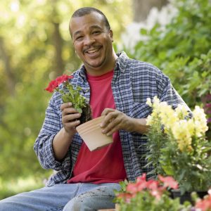 Black man sitting in a garden