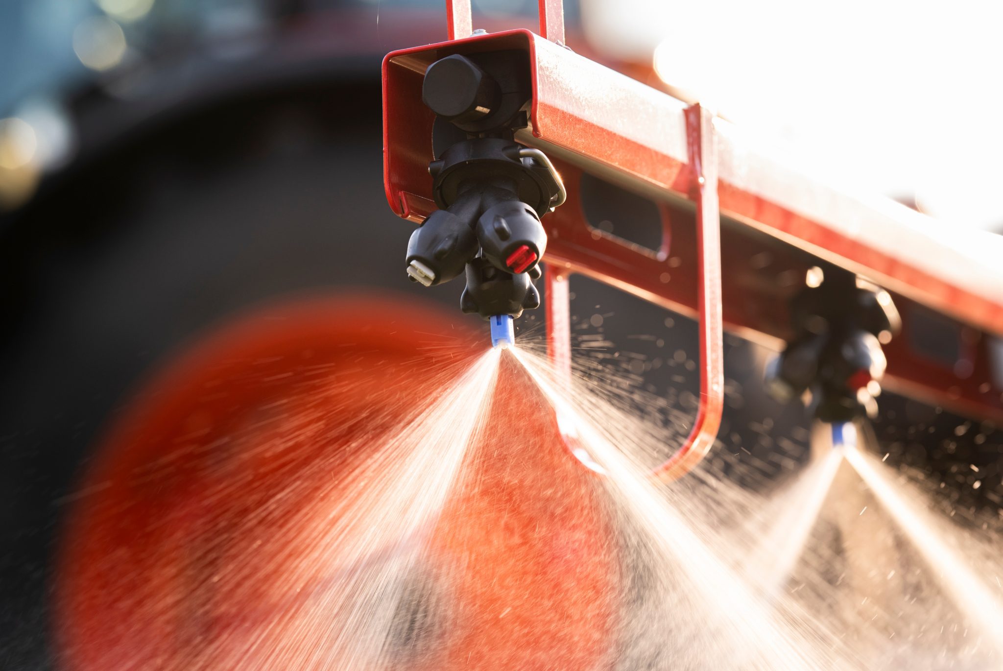 A close up of sprayer nozzles on a tractor