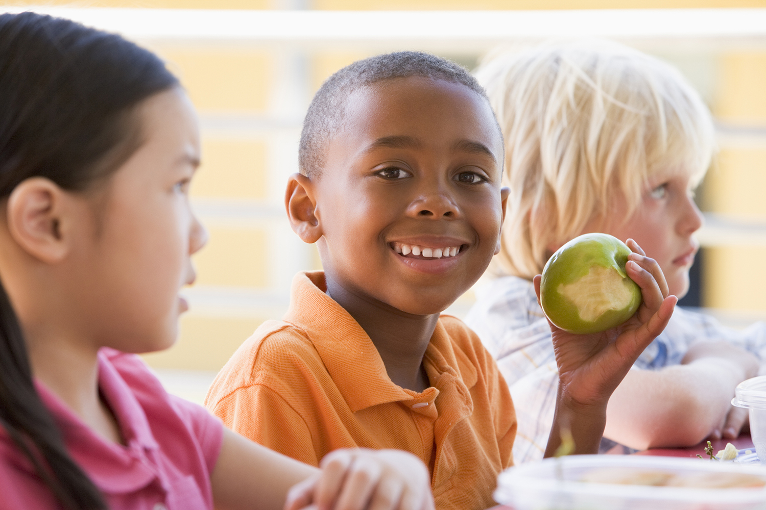 EFNEP impacts; Kindergarten children eating lunch smiling at camera