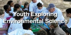 A group of elementary students participate in a watershed demonstration