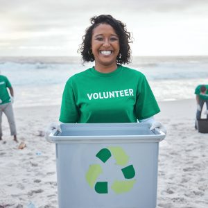 Recycle, box and portrait of woman at beach for plastic, environment and earth day cleaning. Recycling, sustainability and climate change with volunteer and trash for pollution and eco friendly