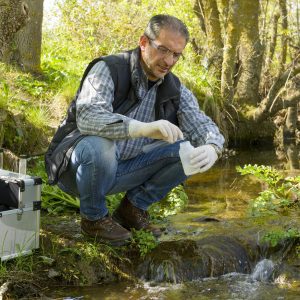 Scientist and biologist hydro-biologist takes water samples for analysis.