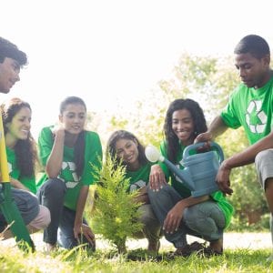 Group of environmentalists planting together in park
