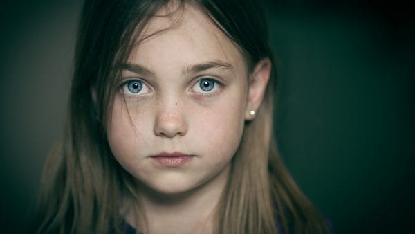 Young girl with blue eyes staring into the camera
