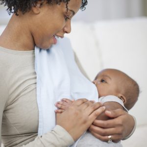 Black mother breast feeding her baby boy.