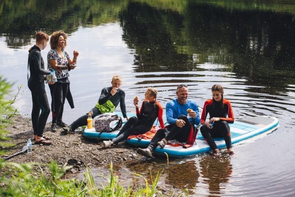 Group of people paddle boarding on a lake