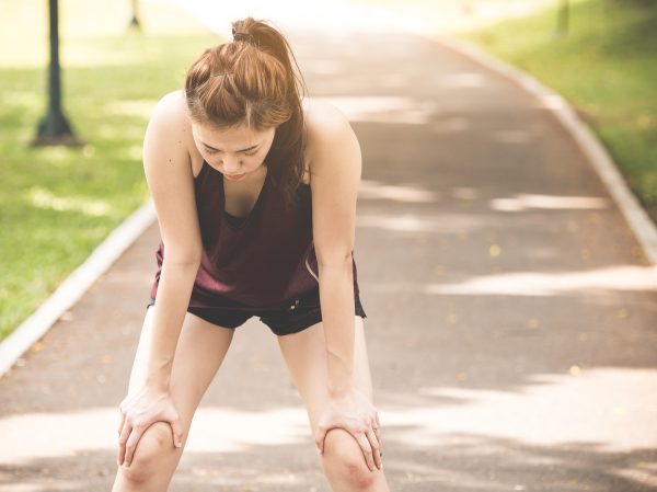Young woman exhausted from running outside