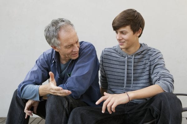 Father and son sitting together