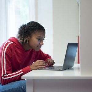 Teenage girl at desk on a computer