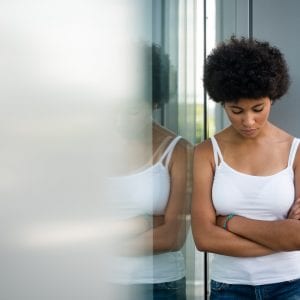 Disappointed young girl posing with folded arms