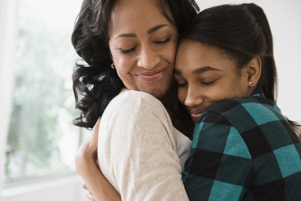 Mother and daughter hugging