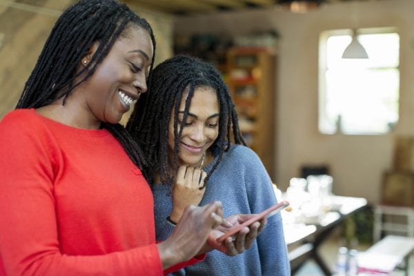 Mother and daughter using smart phone