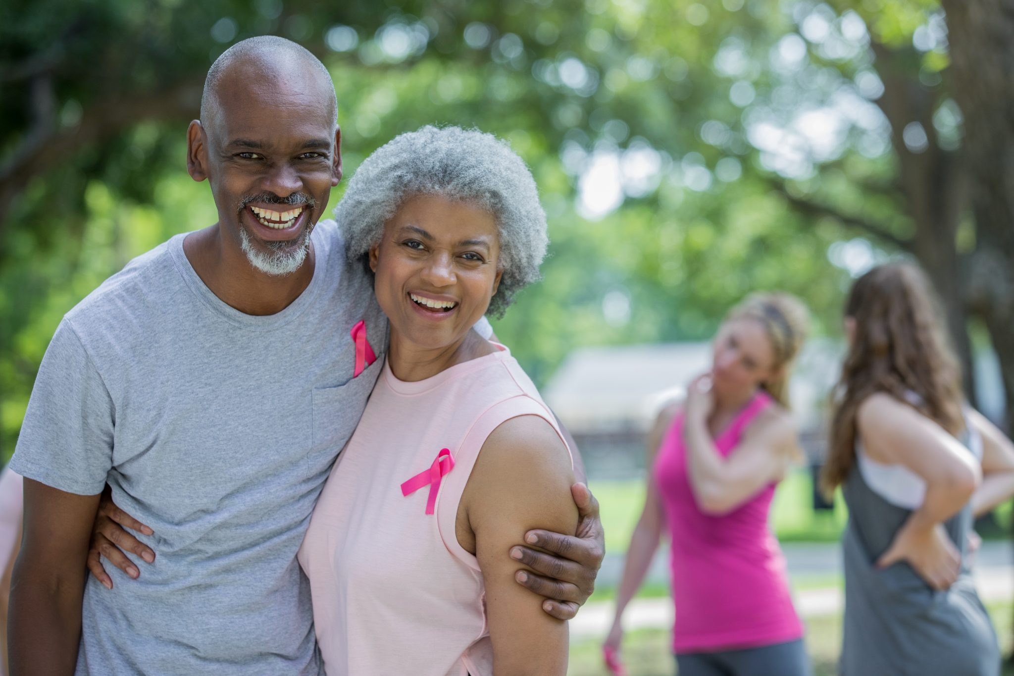 Senior couple attending charity breast cancer race for the cure.