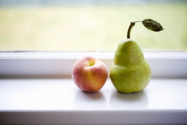 Peach and pear on window sill