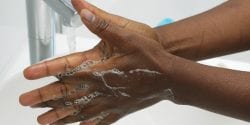 An African American hand washing. Part of Surgical Scrub Technique for Hand Decontamination