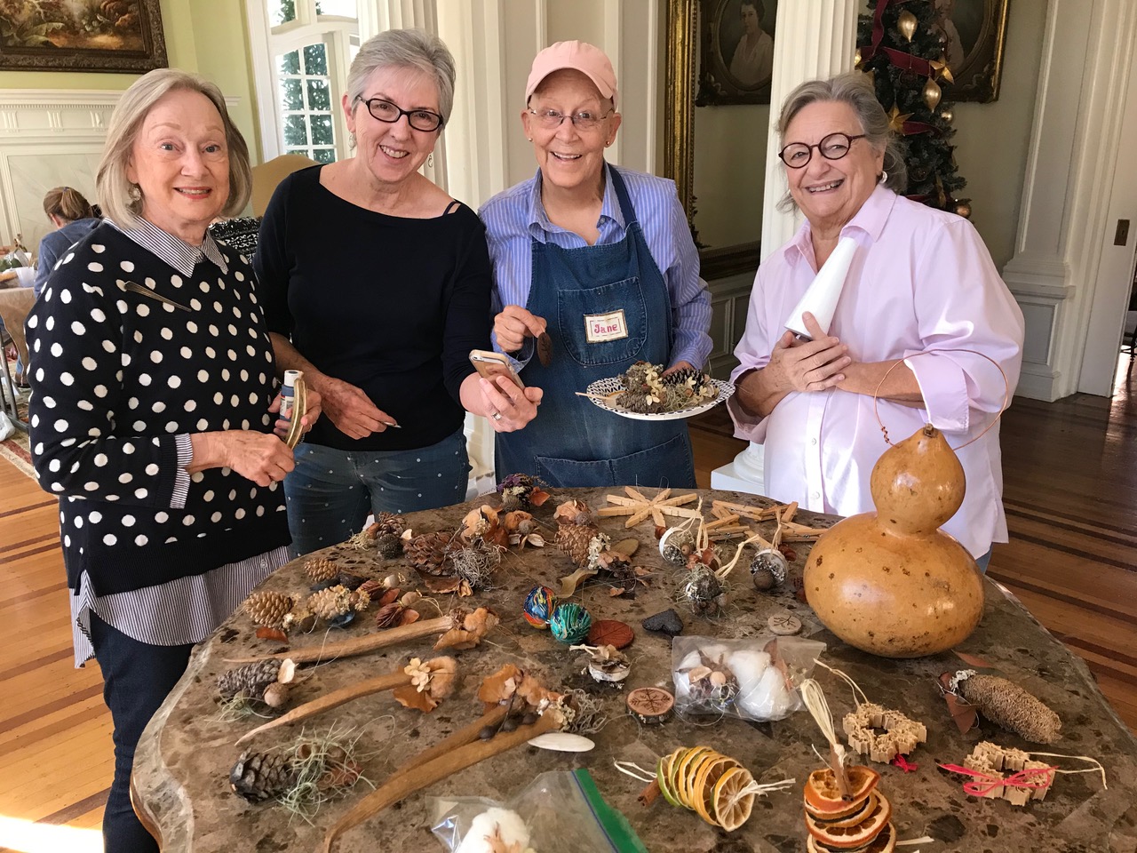 A group of ladies making Christmas decorations.
