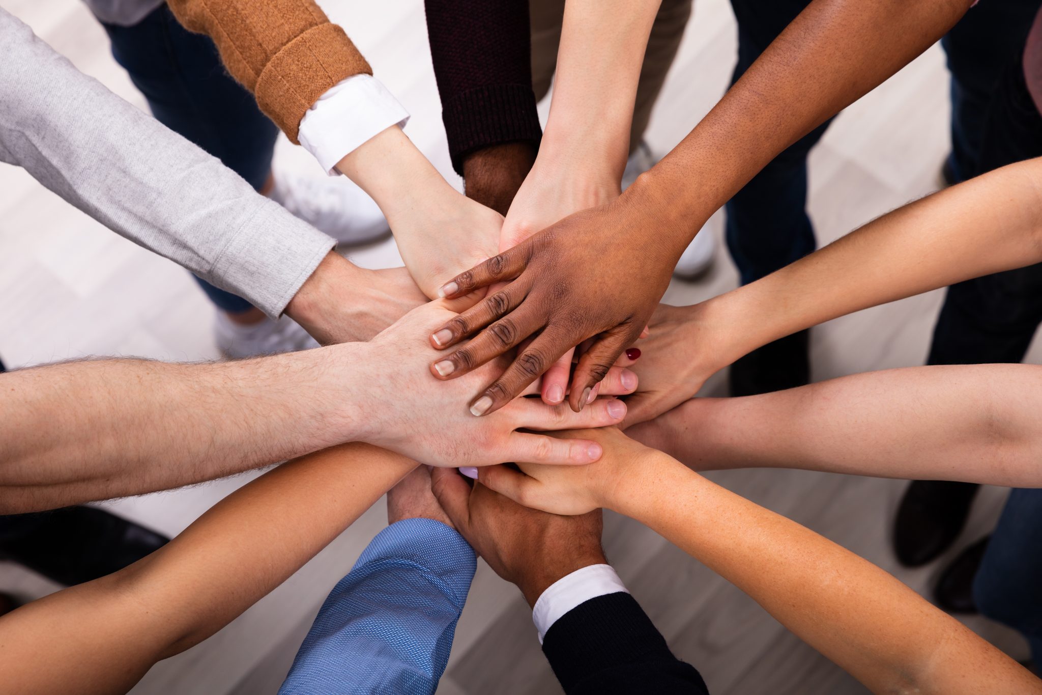 High Angle View Of Multiracial Friend Stacking Hand Together