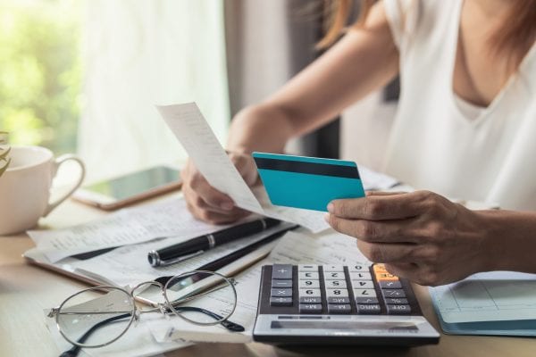 Woman with bills and credit card.