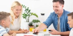 Family playing a game at the table.
