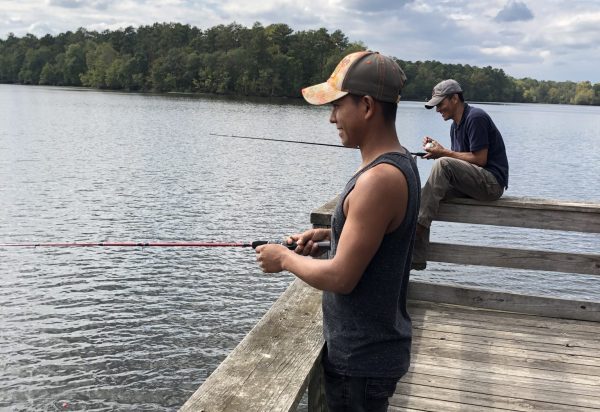 Two men fishing on a dock