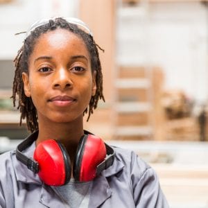 Portrait of young black female worker in a furniture factory