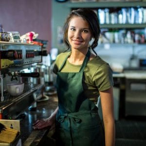 Portrait of teenage waitress in coffee house