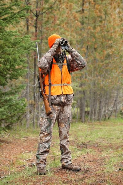 Deer hunter using binoculars